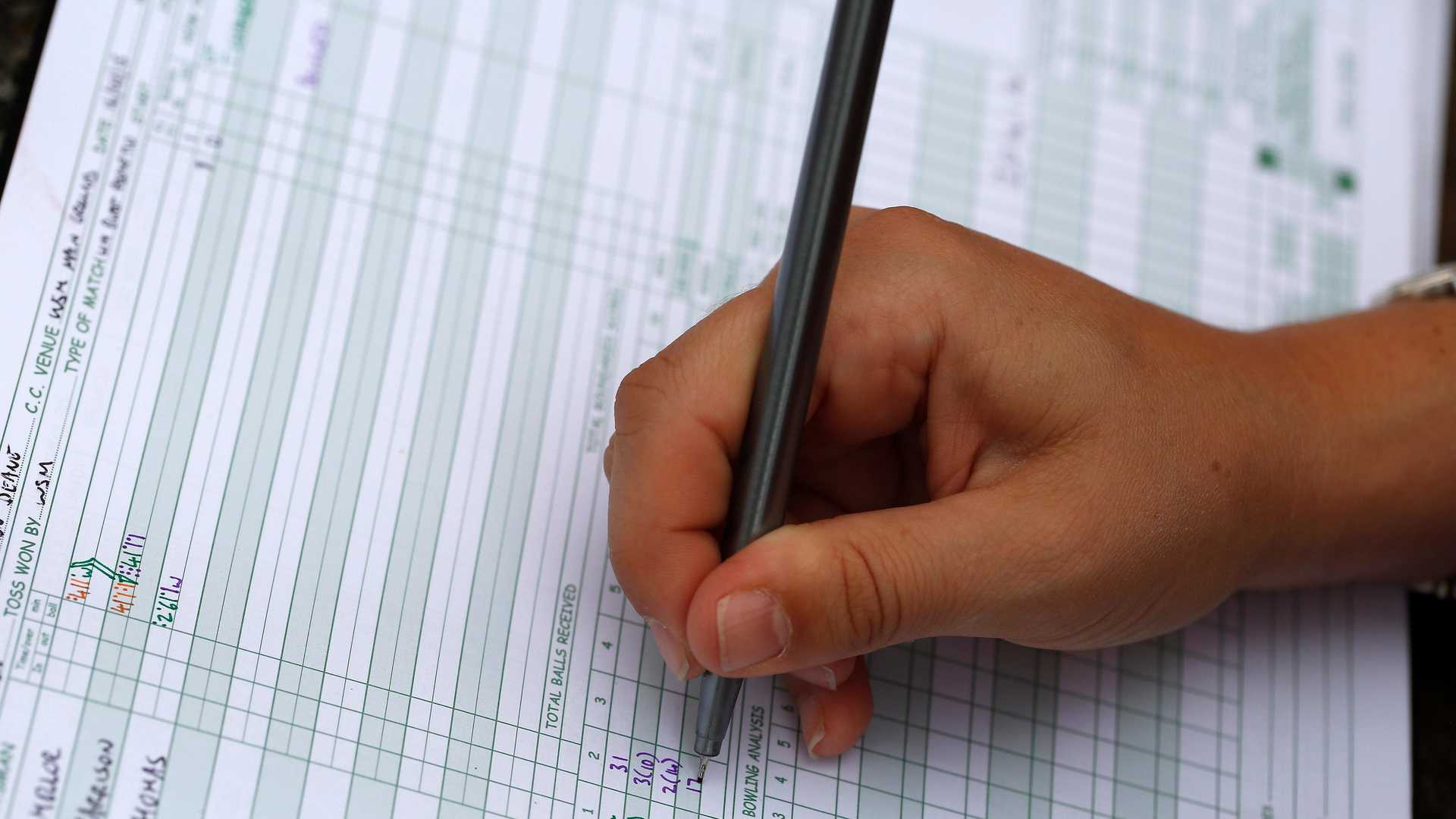 Scorebook and tablet ready for scoring a cricket match